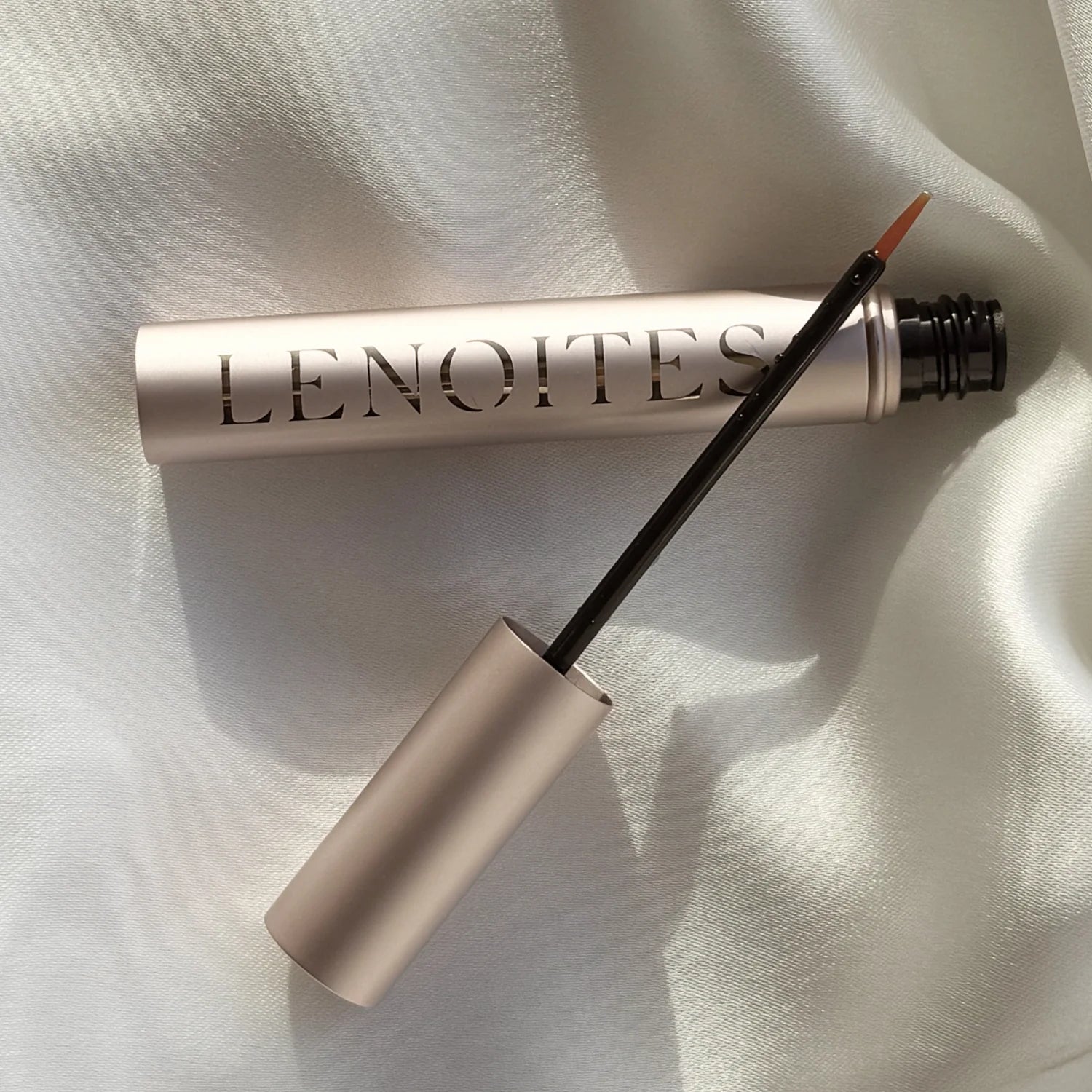 Lenoites Eyelash Growth Serum on a white silk background