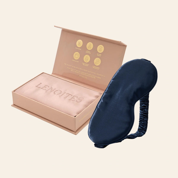 Pillowcase and Sleep Mask in Mulberry Silk by Lenoites featuring a blue silk sleep mask and a pink mulberry silk pillowcase presented in an open blush pink box against a soft light background.
