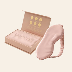 Pillowcase and Sleep Mask in Mulberry Silk by Lenoites featuring a pink silk sleep mask and a pink mulberry silk pillowcase presented in an open blush pink box against a soft light background.